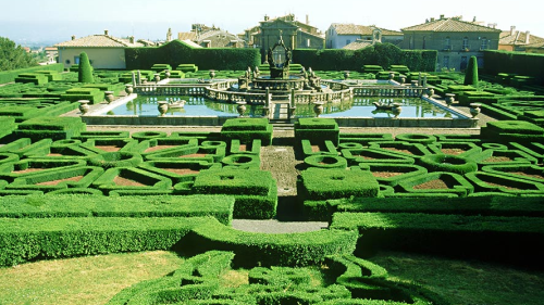 A maze garden with a fountain in the middle